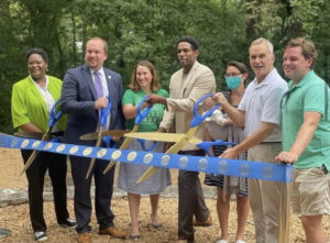 group of city officials inaugrating the park in a ribbon cutting